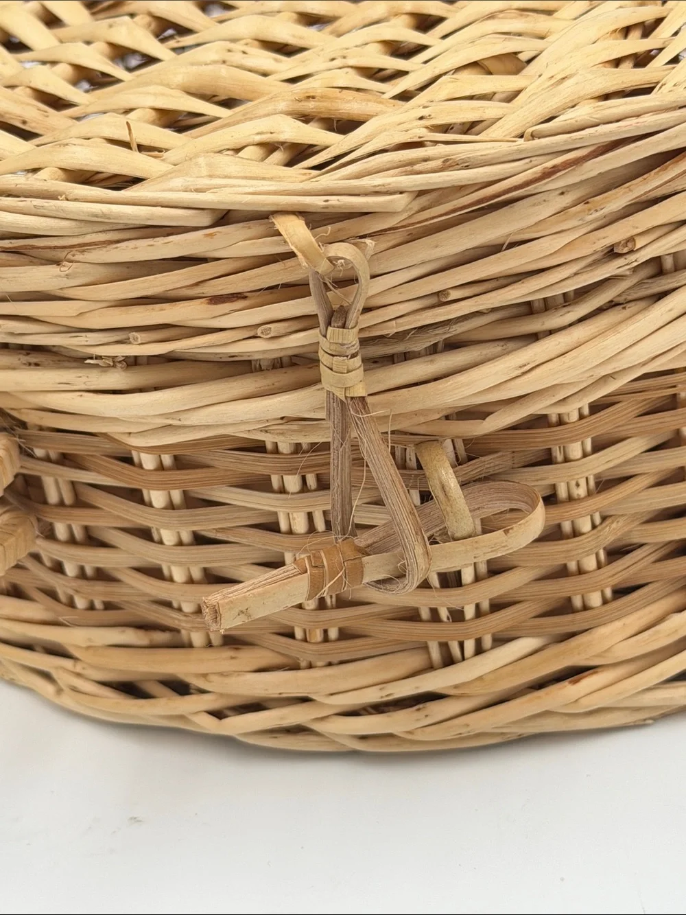 A Cute, charming vintage shell-shaped rattan storage basket with a front handle.